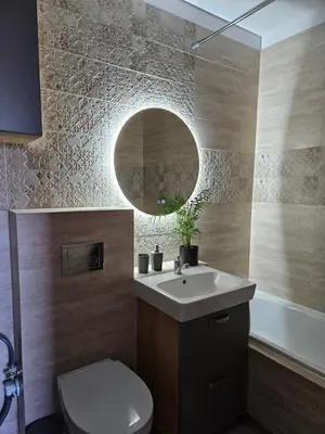 a bathroom with a sink and a toilet and a mirror at Vilniaus apartamentai in Vilnius