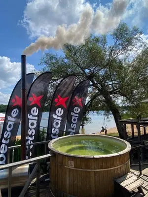 a barrel with smoke coming out of it at 6 vietų namelis ant ežero kranto in Sudervė