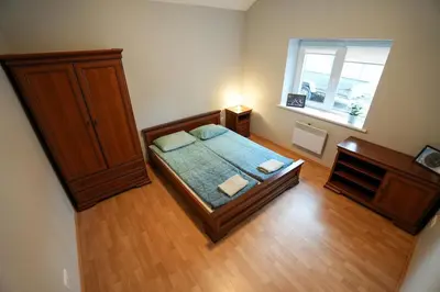 a small bedroom with a bed and a window at 6 vietų namelis ant ežero kranto in Sudervė