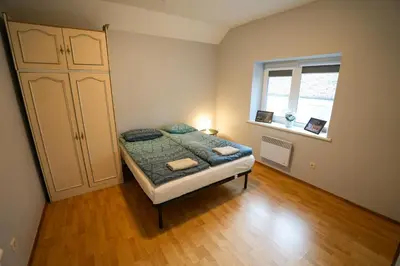 a small bedroom with a bed and a window at 6 vietų namelis ant ežero kranto in Sudervė