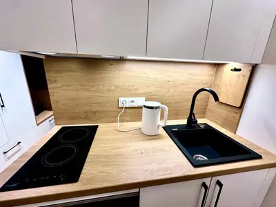 a kitchen with a counter with a stove and a sink at Brand new studio in the center in Vilnius
