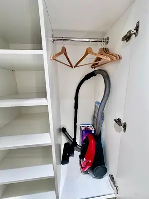 a room with a vacuum cleaner in a closet at Brand new studio in the center in Vilnius