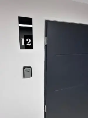 a black door with the number two on a wall at Brand new studio in the center in Vilnius