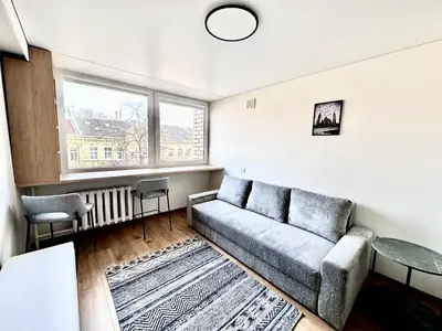 a living room with a couch and a table at Brand new studio in the center in Vilnius