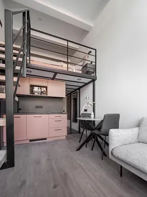 a living room with a loft bed and a table at Pinky loft in City centre Self check-in No 3 in Vilnius