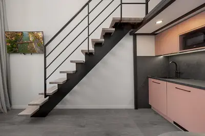 a staircase in a room with a kitchen and a sink at Pinky loft in City centre Self check-in No 3 in Vilnius