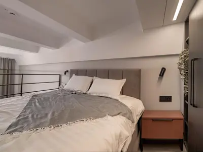 a bedroom with a large bed and a nightstand at Rusty Red loft in City centre Self check-in No 2 in Vilnius