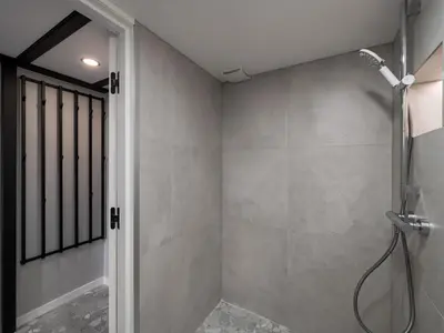a bathroom with a shower with a glass door at Rusty Red loft in City centre Self check-in No 2 in Vilnius