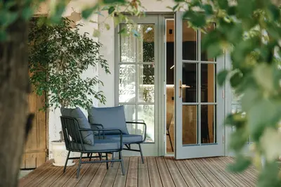 two chairs sitting on a porch next to a door at Luxury Courtyard Old-Town Residence in Vilnius