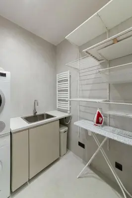 a white kitchen with a sink and a refrigerator at Luxury Courtyard Old-Town Residence in Vilnius