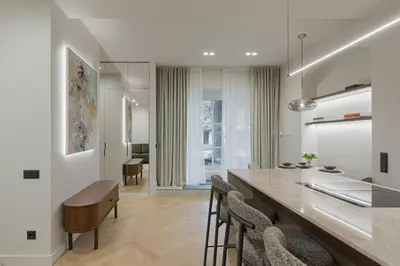 a kitchen and dining room with a long table and chairs at Luxury Courtyard Old-Town Residence in Vilnius