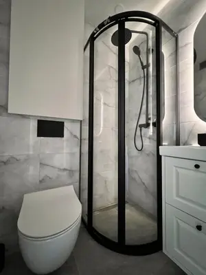 a bathroom with a shower and a toilet in it at Žvėryno studija in Vilnius