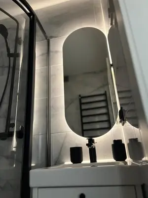 a bathroom with a mirror and a sink at Žvėryno studija in Vilnius