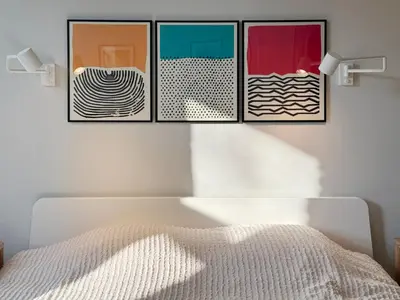 a bedroom with four pictures hanging above a bed at Stepono Apartment in Vilnius