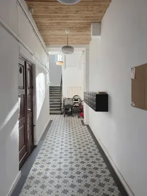 an empty hallway with a tile floor and a door at Stepono Apartment in Vilnius