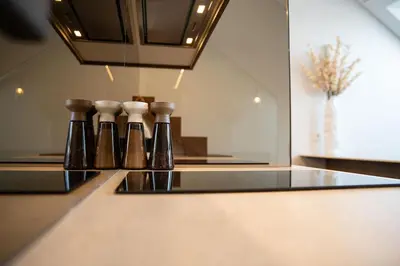 a row of bottles sitting on top of a counter at M 8 apartment in Kaunas