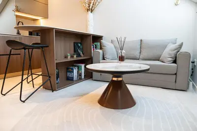 a living room with a couch and a table at M 8 apartment in Kaunas