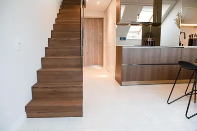 a staircase leading up to a kitchen with a counter at M 8 apartment in Kaunas