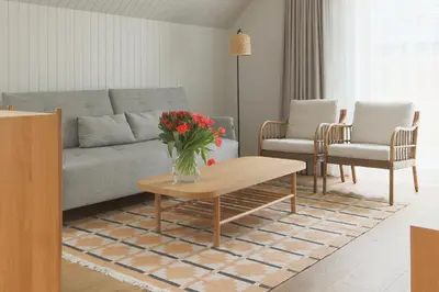 a living room with a couch and a table at Vila 44 in Druskininkai