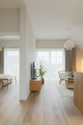 a living room with a television and a couch at Vila 44 in Druskininkai