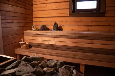 a pair of shoes sitting on a bench in a cabin at Sodyba prie Vidinksto ežero in Pakalniai