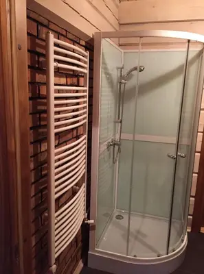 a shower with a glass door in a bathroom at Sodyba prie Vidinksto ežero in Pakalniai