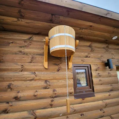 a barrel on the side of a building with a window at Vipoilsis Namelis N3 in Čekoniškės