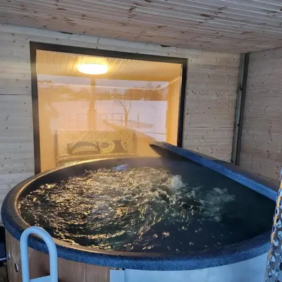 a large tub filled with water in a room at Vipoilsis Namelis N3 in Čekoniškės