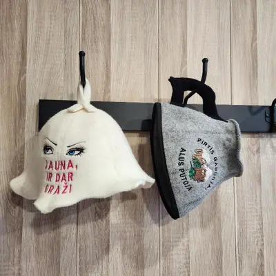 a hat and a bag hanging on a belt at Vipoilsis Namelis N3 in Čekoniškės