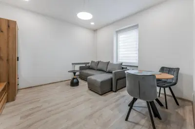 a living room with a couch and a table at Centrinis butas šalia senvagės in Panevėžys