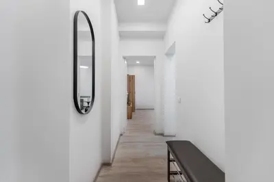 a mirror on a wall in a hallway at Centrinis butas šalia senvagės in Panevėžys