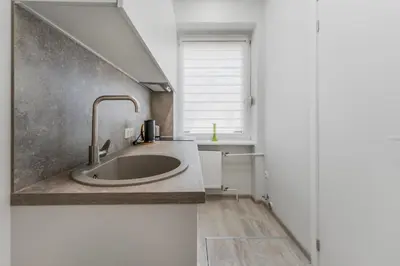 a kitchen with a sink and a window at Centrinis butas šalia senvagės in Panevėžys