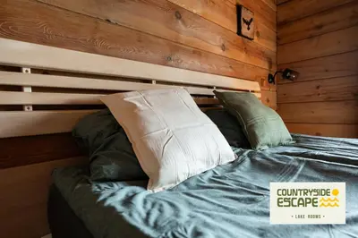 a bed with pillows on it in a room at Countryside Escape - Lake Rooms in Trakai