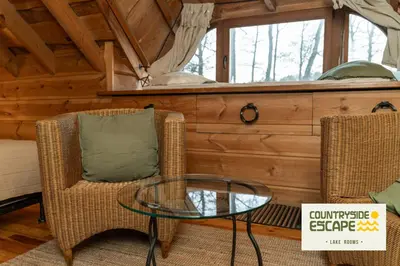 a room with two chairs and a glass table at Countryside Escape - Lake Rooms in Trakai