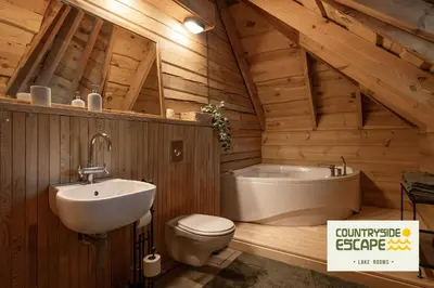 a bathroom with a toilet and a sink and a tub at Countryside Escape - Lake Rooms in Trakai