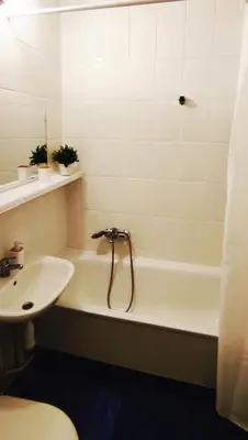 a bathroom with a sink and a bath tub next to a toilet at Prime Location Apartment Vilnius in Vilnius
