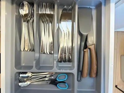 a drawer filled with utensils and cutlery at Feel Comfy Apartment in Druskininkai