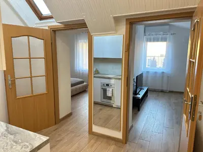 an open door to a room with a kitchen at Feel Comfy Apartment in Druskininkai