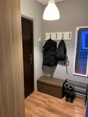 a room with a bed and a door and a bag at KRL&Lu Rentals in Panevėžys