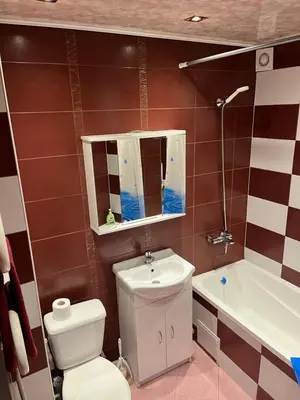 a bathroom with a toilet and a sink and a tub at KRL&Lu Rentals in Panevėžys