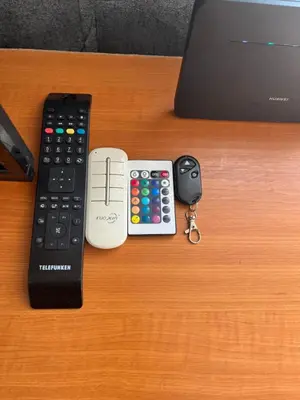 a remote control and a calculator and keys on a table at KRL&Lu Rentals in Panevėžys