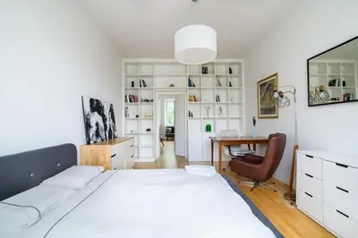 a bedroom with a large bed and a desk at Charming flat with Great Location by URBAN RENT in Vilnius