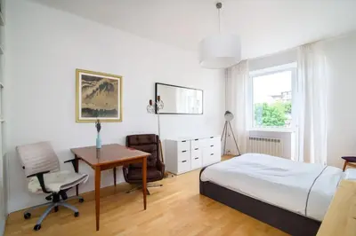 a bedroom with a bed and a desk and a table at Charming flat with Great Location by URBAN RENT in Vilnius
