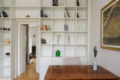 a room with white shelves with books at Charming flat with Great Location by URBAN RENT in Vilnius