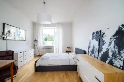 a bedroom with a bed and a desk in it at Charming flat with Great Location by URBAN RENT in Vilnius
