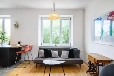 a living room with a couch and two windows at Charming flat with Great Location by URBAN RENT in Vilnius