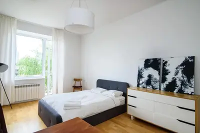 a bedroom with a large bed and a dresser at Charming flat with Great Location by URBAN RENT in Vilnius