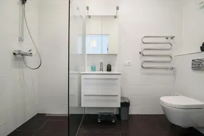 a white bathroom with a sink and a toilet at Charming flat with Great Location by URBAN RENT in Vilnius