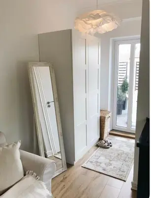 a living room with a mirror and a couch at Private, Cozy Home in Kaunas