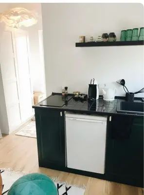 a kitchen with a black and white counter top at Private, Cozy Home in Kaunas